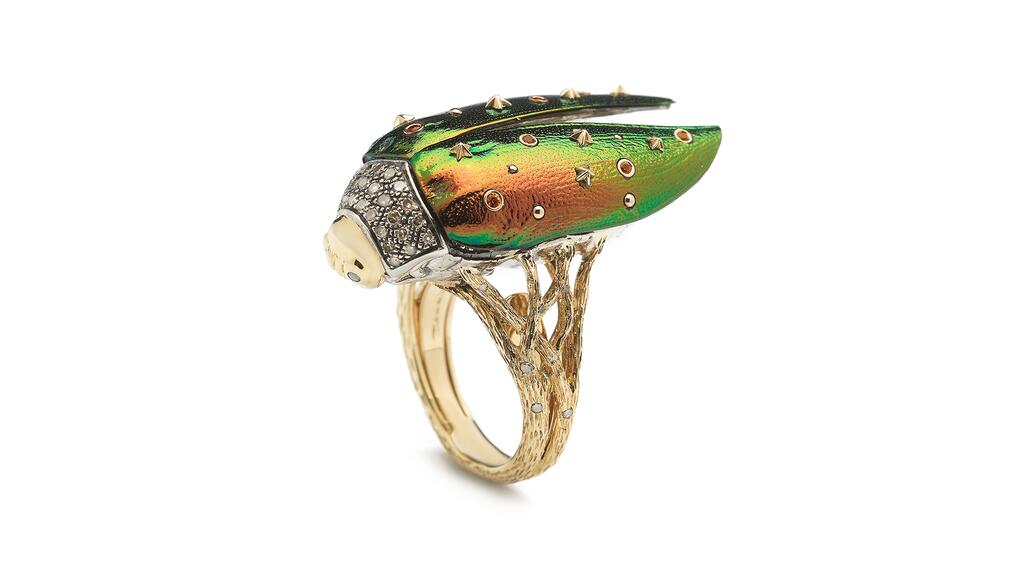 The 18-karat yellow gold and sterling silver “Scarab Fly” ring by Bibi van der Velden, featuring real scarab wings, white and brown diamonds, green tsavorite, and orange and yellow sapphires ($11,870) Bibi van der Velden scarab ring